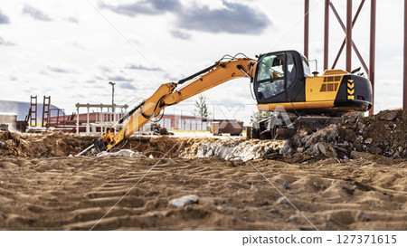 Professional demolition of reinforced concrete structures using industrial hydraulic hammer with excavator. Rods of metal fittings. Wreckage and crumbles of concrete. Professional demolition of reinforced concrete structures using industrial hydraulic hammer with excavator. Rods of metal fittings. Wreckage and crumbles of concrete. 127371615