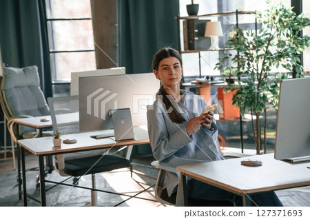 Beautiful young woman is working in the office 127371693