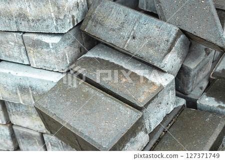 Stacked concrete bricks ready for construction in a building site during daylight hours 127371749