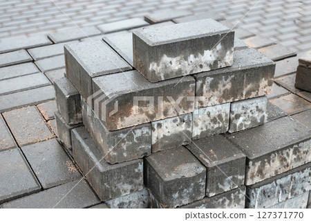 Construction project featuring stacked bricks in a building site during daylight hours Construction project featuring stacked bricks in a building site during daylight hours 127371770