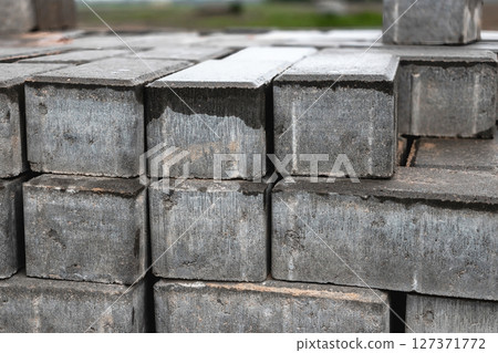 Cinder blocks stacked for construction in a building site during midday 127371772