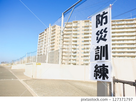 A sign announcing disaster drills in a residential area 127371797