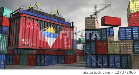 Cargo container with flag of Antigua and Barbuda lifted by crane at freight terminal - 3D illustration 127372060