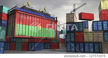 Cargo container with flag of Burkina Faso lifted by crane at freight terminal - 3D illustration Cargo container with flag of Burkina Faso lifted by crane at freight terminal - 3D illustration 127372074