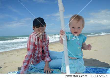 Grandmother and Toddler Enjoying Beach Day Together 127372324