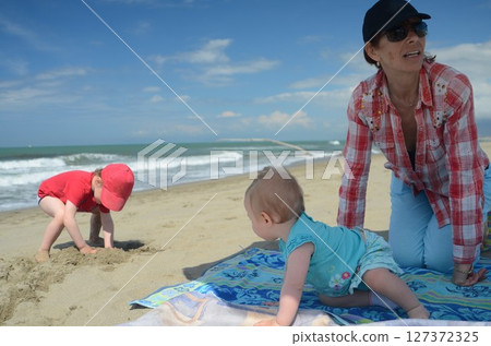 Joyful Day at the Beach with Grandmother and Grandchildren 127372325