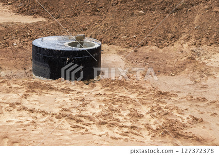 Installation of a reinforced concrete well for water supply and sewerage at the construction site. 127372378
