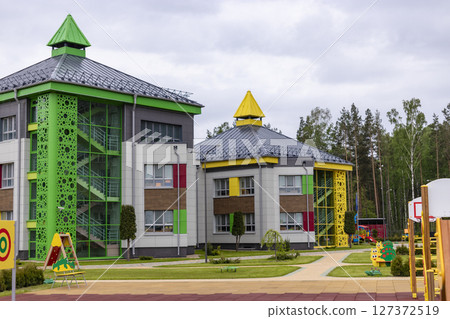 Children's playground in a kindergarten or park. Bright modern outdoor play equipment for children. 127372519