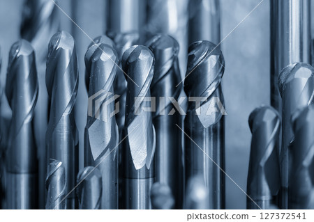 Close-up scene the group of used coating cutter ball nose end mill tools in the light blue scene. 127372541