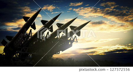 Military missile launcher and dramatic sky at sunset - defense concept - 3D illustration 127372556