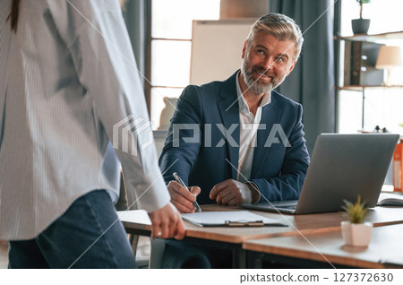Senior man is with woman. Business people are working together in the office Senior man is with woman. Business people are working together in the office 127372630