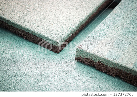 Rubber flooring material displayed in close-up view highlighting texture and color variations indoors 127372703