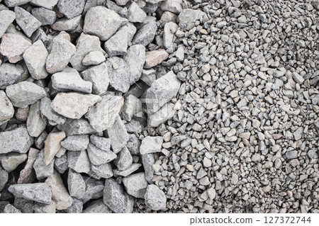 Various sizes of gray stone aggregate ready for construction at a building site 127372744