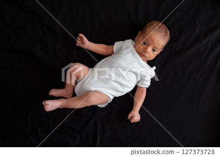 Newborn Baby on Black Background 127373728