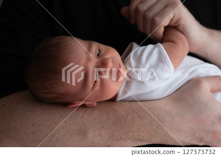 Newborn Baby Cradled in Hand 127373732