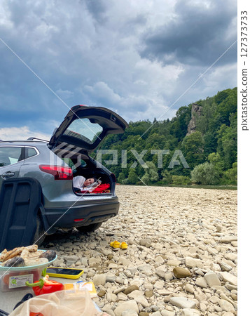 Outdoor Picnic by the Riverbank with SUV 127373733