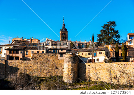Picturesque Segovia cityscape under a bright blue sky. 127373804