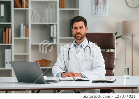 In the cabinet. Doctor in formal clothes is working In the cabinet. Doctor in formal clothes is working 127374021