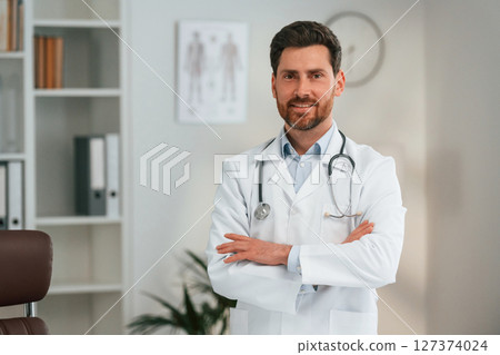In the cabinet. Doctor in formal clothes is working In the cabinet. Doctor in formal clothes is working 127374024