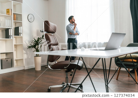 Walking, thinking, waiting for patient. Doctor in formal clothes is working in the cabinet 127374034