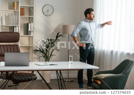 Walking, thinking, waiting for patient. Doctor in formal clothes is working in the cabinet Walking, thinking, waiting for patient. Doctor in formal clothes is working in the cabinet 127374035