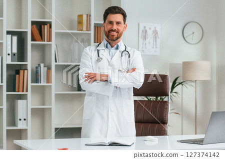 With stethoscope. Doctor in formal clothes is working in the cabinet 127374142