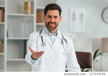 Standing in the office. Doctor in formal clothes is working in the cabinet 127374144