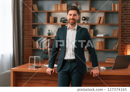 Businessman in formal clothes is working indoors Businessman in formal clothes is working indoors 127374165
