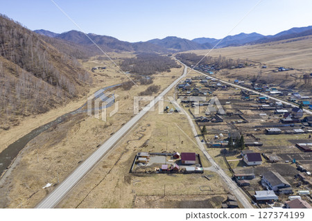 Aerial view of the village of Cherga at the mountains and the Sema River in the Altai Mountains 127374199