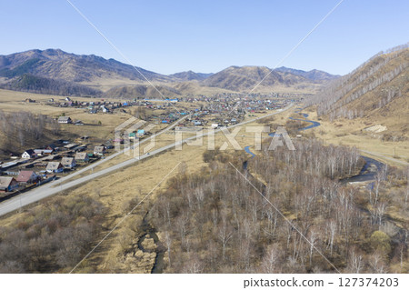 Aerial view of the village of Cherga at the mountains and the Sema River in the Altai Mountains 127374203