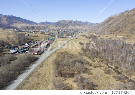 Aerial view of the village of Cherga at the mountains and the Sema River in the Altai Mountains 127374204