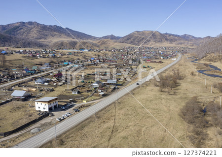 Aerial view of the village of Cherga at the mountains and the Sema River in the Altai Mountains 127374221