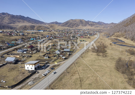 Aerial view of the village of Cherga at the mountains and the Sema River in the Altai Mountains 127374222