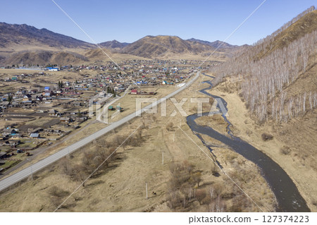 Aerial view of the village of Cherga at the mountains and the Sema River in the Altai Mountains 127374223