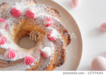 Traditional Easter cakes with icing decorated candies on white wooden table Traditional Easter cakes with icing decorated candies on white wooden table 127374261