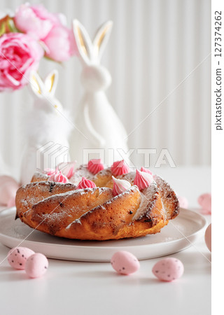 Traditional Easter cakes with icing decorated candies on white wooden table Traditional Easter cakes with icing decorated candies on white wooden table 127374262