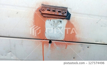 Old Wall Panel Mount With Rusty Metal and Paint Drips on a Weathered Surface Old Wall Panel Mount With Rusty Metal and Paint Drips on a Weathered Surface 127374496