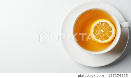 Cup of hot tea with a slice of lemon served on a white saucer on white background. Simple and refreshing warm drink. Minimalist composition. 127374535