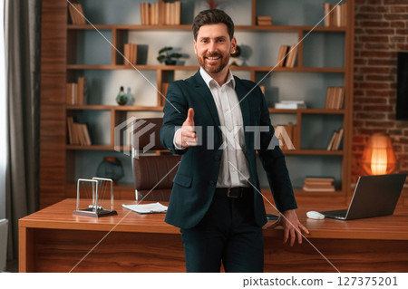Greetings, giving the hand. Businessman in formal clothes is working indoors 127375201