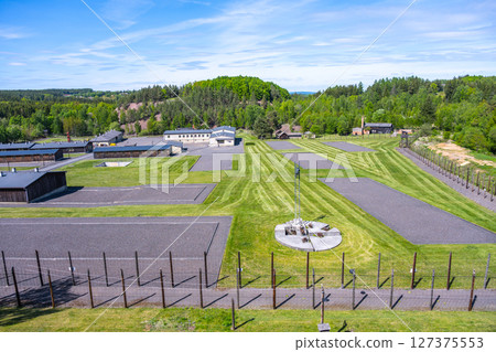 This memorial in Lesetice honors victims of communism, showcasing a former prison complex surrounded by green landscapes and carefully maintained grounds under a clear sky. This memorial in Lesetice honors victims of communism, showcasing a former prison complex surrounded by green landscapes and carefully maintained grounds under a clear sky. 127375553
