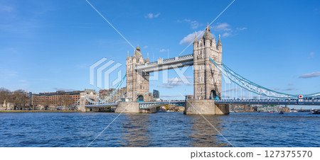 Tower Bridge stands majestically over the River Thames, showcasing its iconic structure against a clear blue sky. Visitors can admire the beauty of London from this historic landmark. Tower Bridge stands majestically over the River Thames, showcasing its iconic structure against a clear blue sky. Visitors can admire the beauty of London from this historic landmark. 127375570