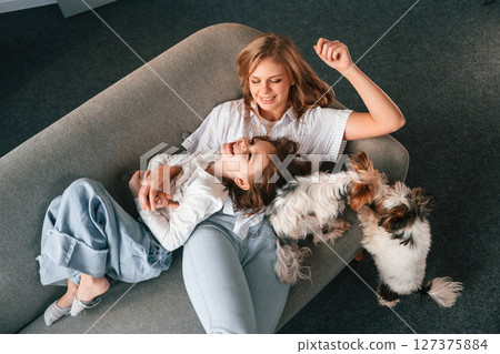Top view. Mother with her daughter and with cute dog is in domestic room 127375884