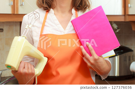 Housekeeper with cookbook and mixer 127376036