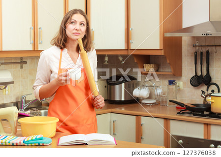 Housewife planning and preparing meal Housewife planning and preparing meal 127376038