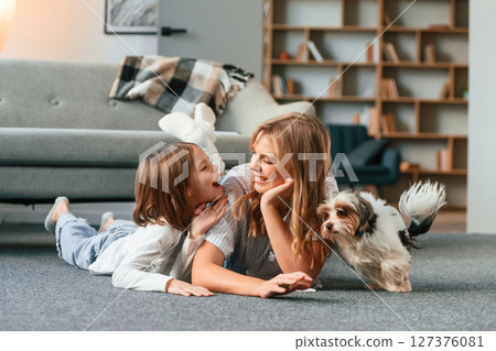 Beautiful animal. Mother with her daughter and with cute dog is in domestic room 127376081