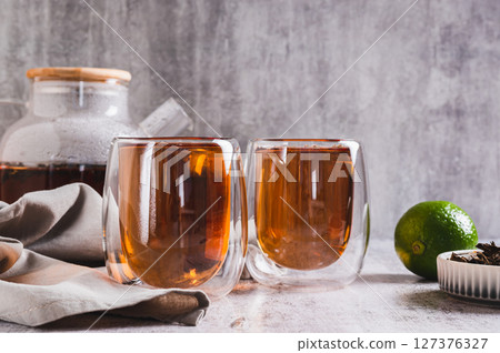 Earl Grey tea with bergamot in cups and teapot on table Earl Grey tea with bergamot in cups and teapot on table 127376327