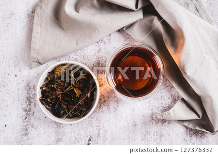 Close up of Earl Grey tea with bergamot in a cup on table top view Close up of Earl Grey tea with bergamot in a cup on table top view 127376332