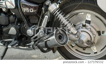 Chrome Exhaust and Rear Wheel on Vintage Motorcycle 127376532
