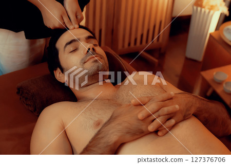 Caucasian man enjoying relaxing anti-stress head massage. Quiescent 127376706