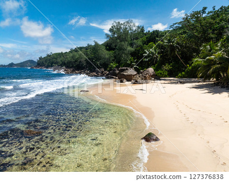 Beautiful beach in the tropics. Seychelles, Mahe. Anse Takamaka Beach. Beautiful beach in the tropics. Seychelles, Mahe. Anse Takamaka Beach. 127376838